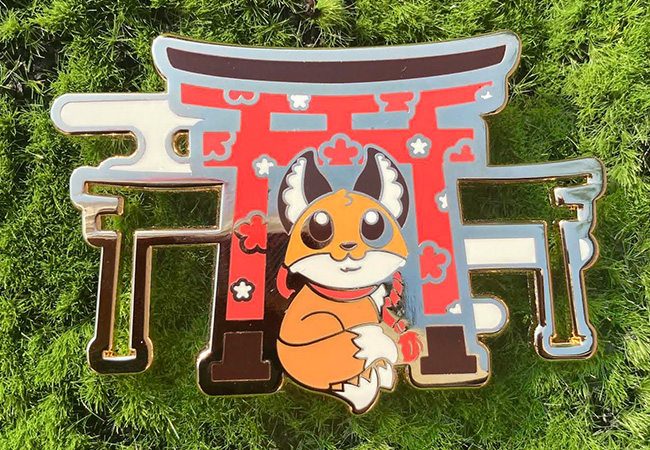 Enamel pin of a wolf in front of a tori gate